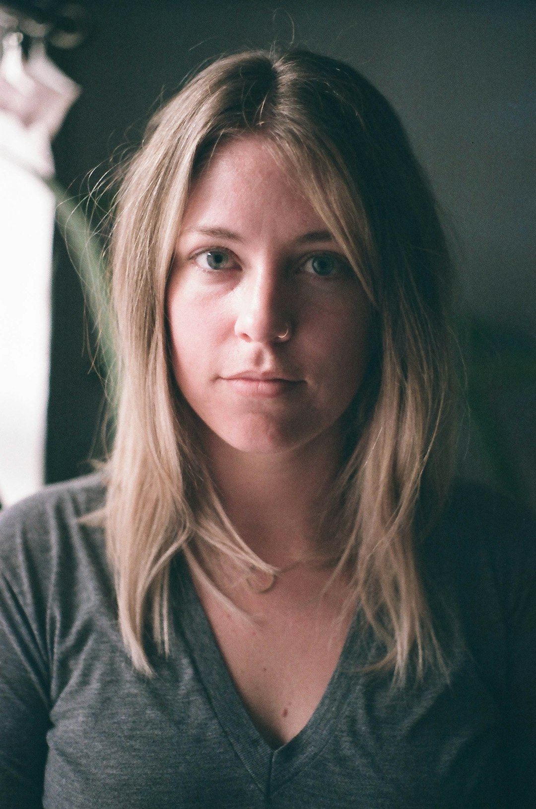 Photo by Ty Carlson woman in gray V-neck top taking a selfie